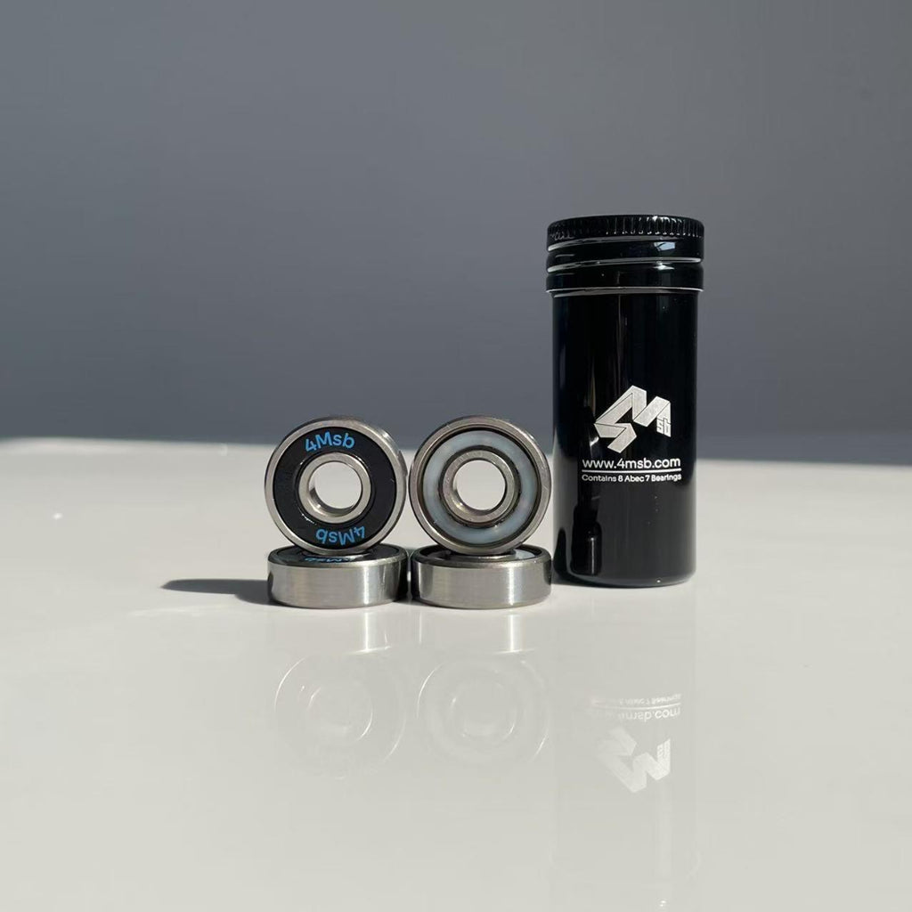 4Msb skateboard bearings ABEC 7 comes in a black tin tube. Four bearings are shown together with the tube which contains 8 bearings in total. They are sold in set by 8.