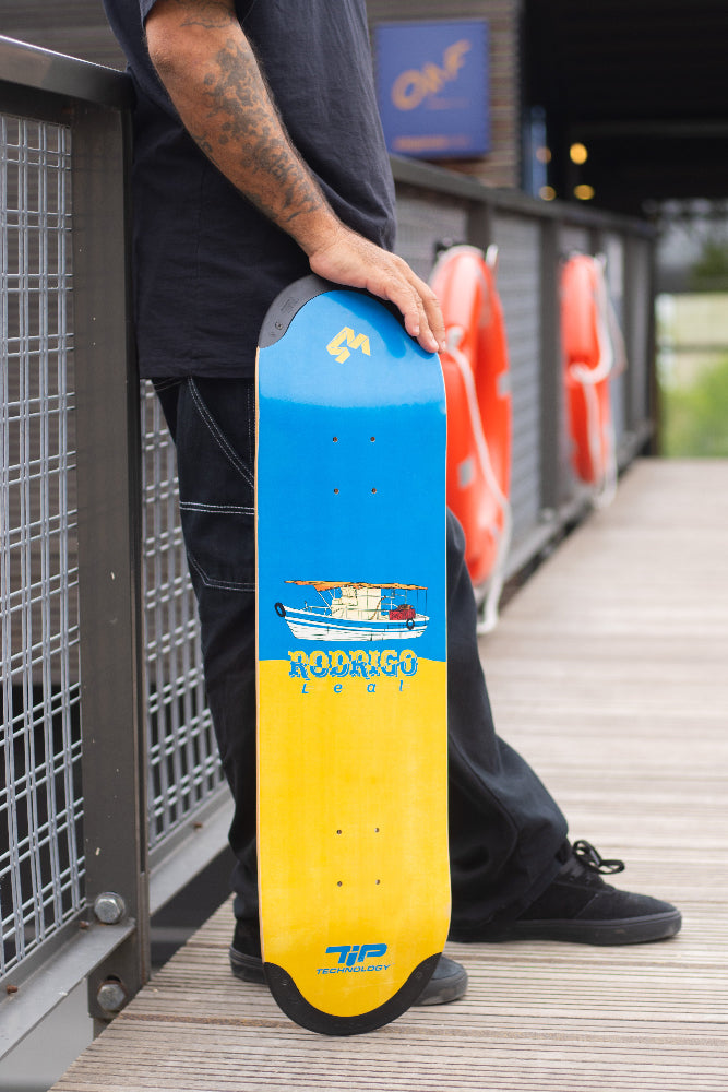 4Msb Pro skater Rodrigo Leal with his signature deck Fisher TIPtech, boat collection, standing on a bridge.