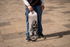 4Msb team rider Hadriel Junior, wearing jeans and black t-shirt, holding the new skateboard deck 4Msb Jättar (giants) with TIPtech in the streets of Sao Paulo, Brazil. The deck is black and white with a giant on a rocky ground, with white background. It's part of the folklore series.