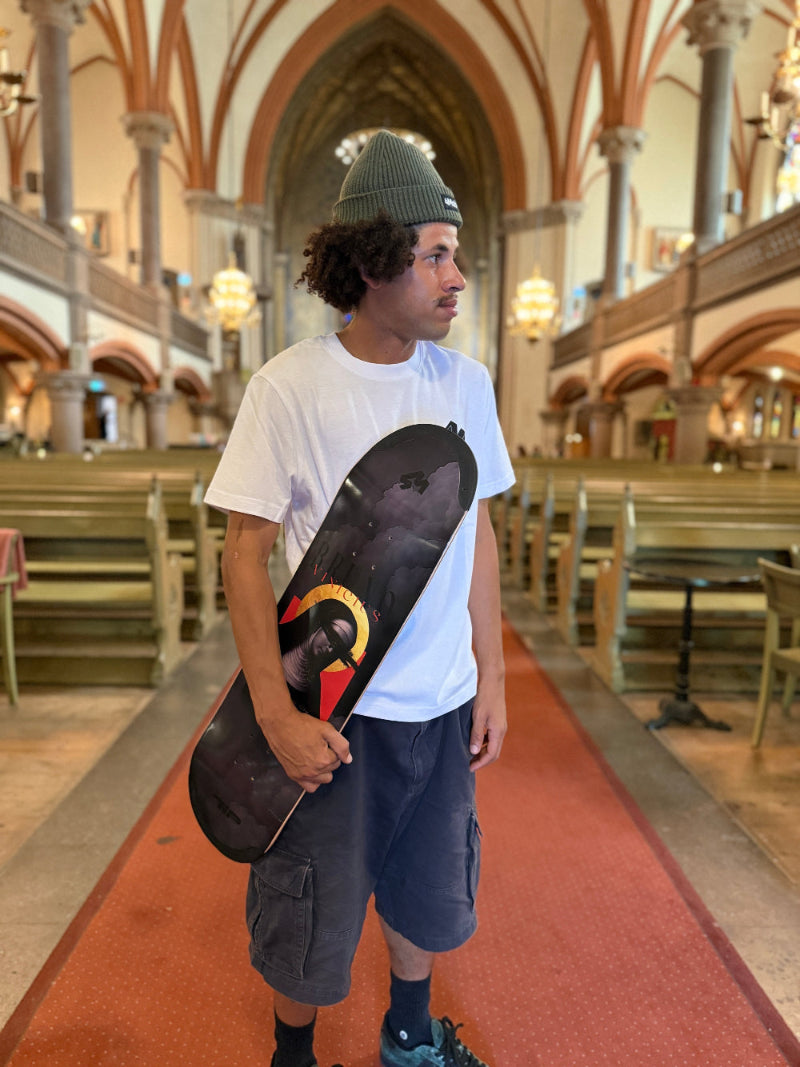 Pro skater Bruno Vinicius standing in the Oscar church in stockholm, sweden, with his 4Msb skateboard deck saint bridget, part of the saints collection.