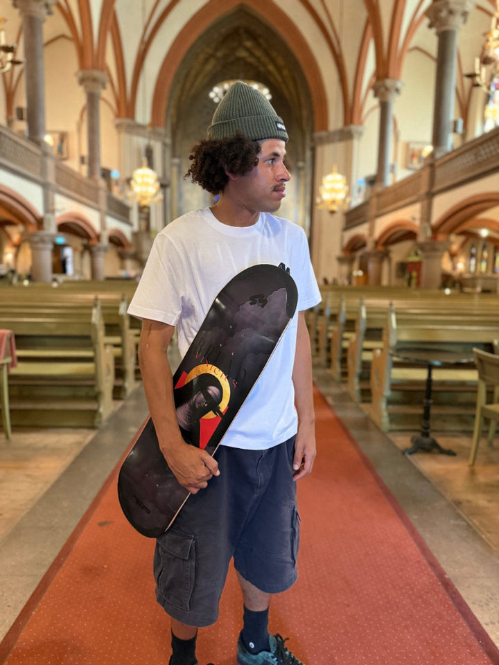 Pro skater Bruno Vinicius standing in the Oscar church in stockholm, sweden, with his 4Msb skateboard deck saint bridget, part of the saints collection.