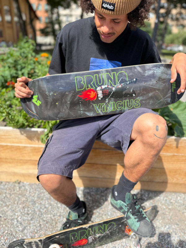 Pro skateboarder Bruno Vinicius with his first Pro model skateboard deck Curupira with TIPtech. The graphic shows Curupira, the protecter of the rain forest and the animals, a Brazilian legend with his famous red fire hair. Photo taken outdoors in Stockholm summer 2026.