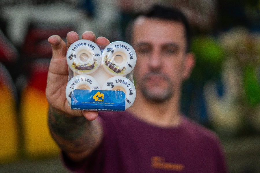 4Msb pro rider Rodrigo Leal showing his signature skateboard wheels 4 pack Drakkar Rodrigo Leal 53mm, white with drakkar boat in brown and gold and text in black.