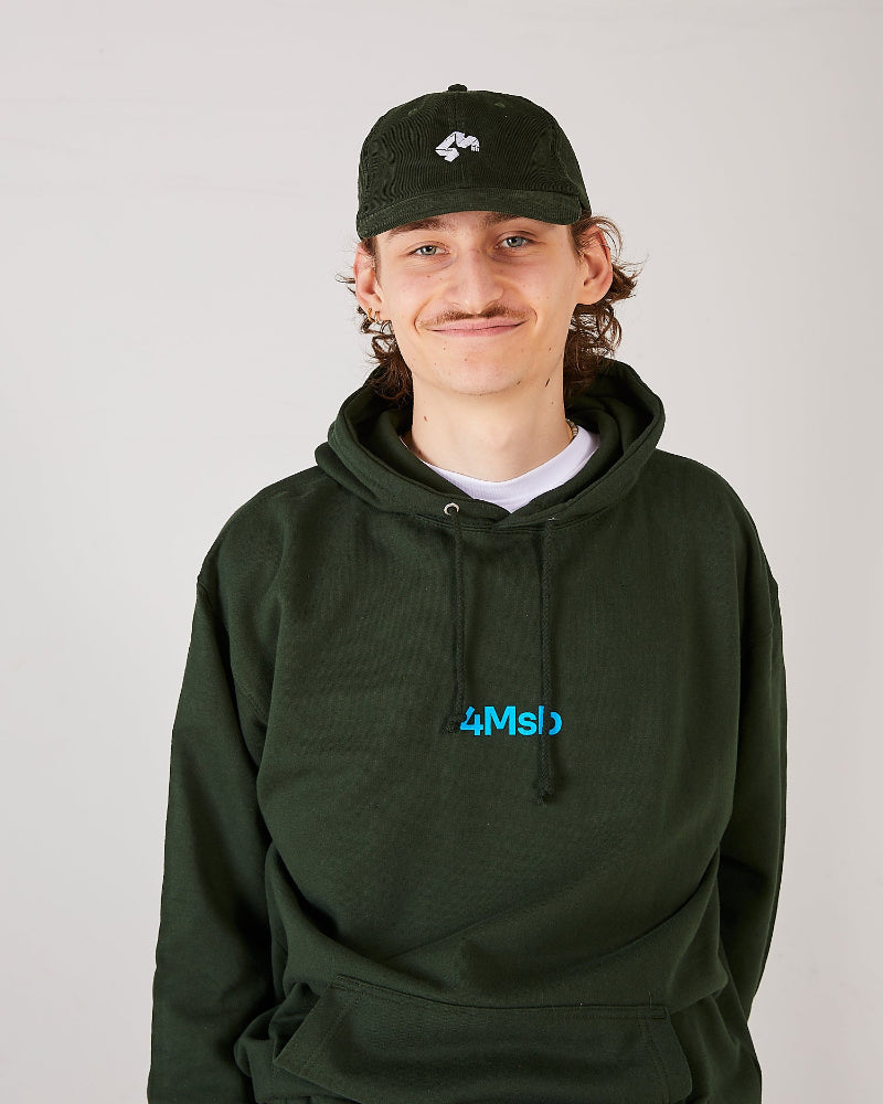 Skater wearing a olive green 4Msb corduroy cap Quatro and a forest green 4Msb hoodie.