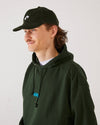 Skater wearing a olive green 4Msb corduroy cap Quatro and a forest green 4Msb hoodie.
