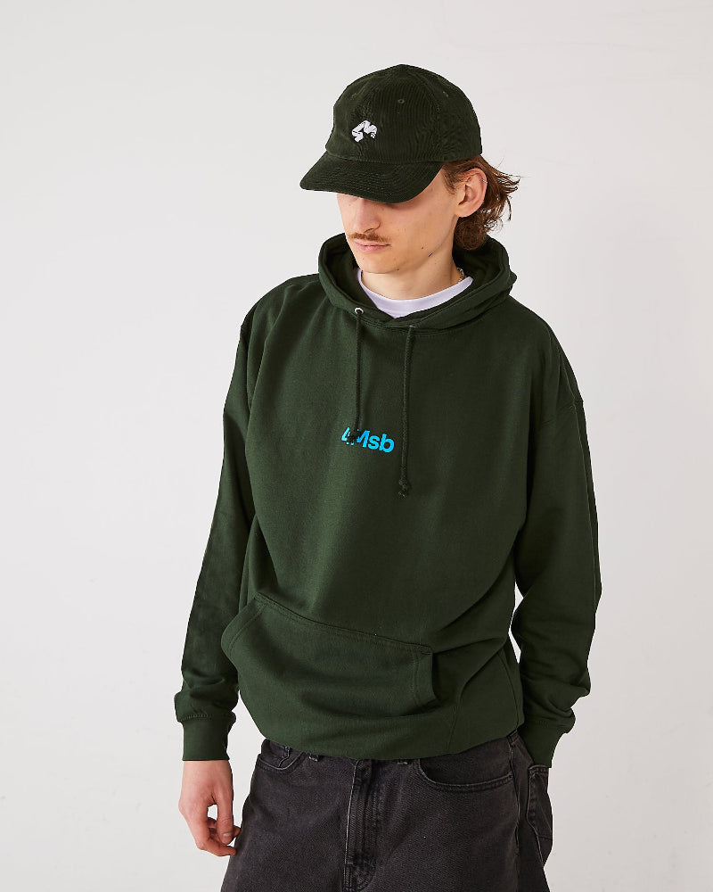 Skater wearing a olive green 4Msb corduroy cap Quatro and a matching forest green 4Msb hoodie.