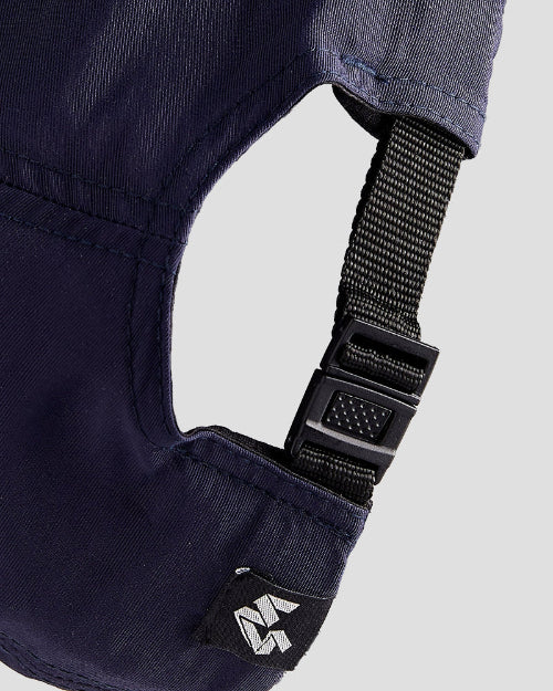 Close-up of a navy blue dad cap, the back, showing a black strap and a small 4Msb logo
