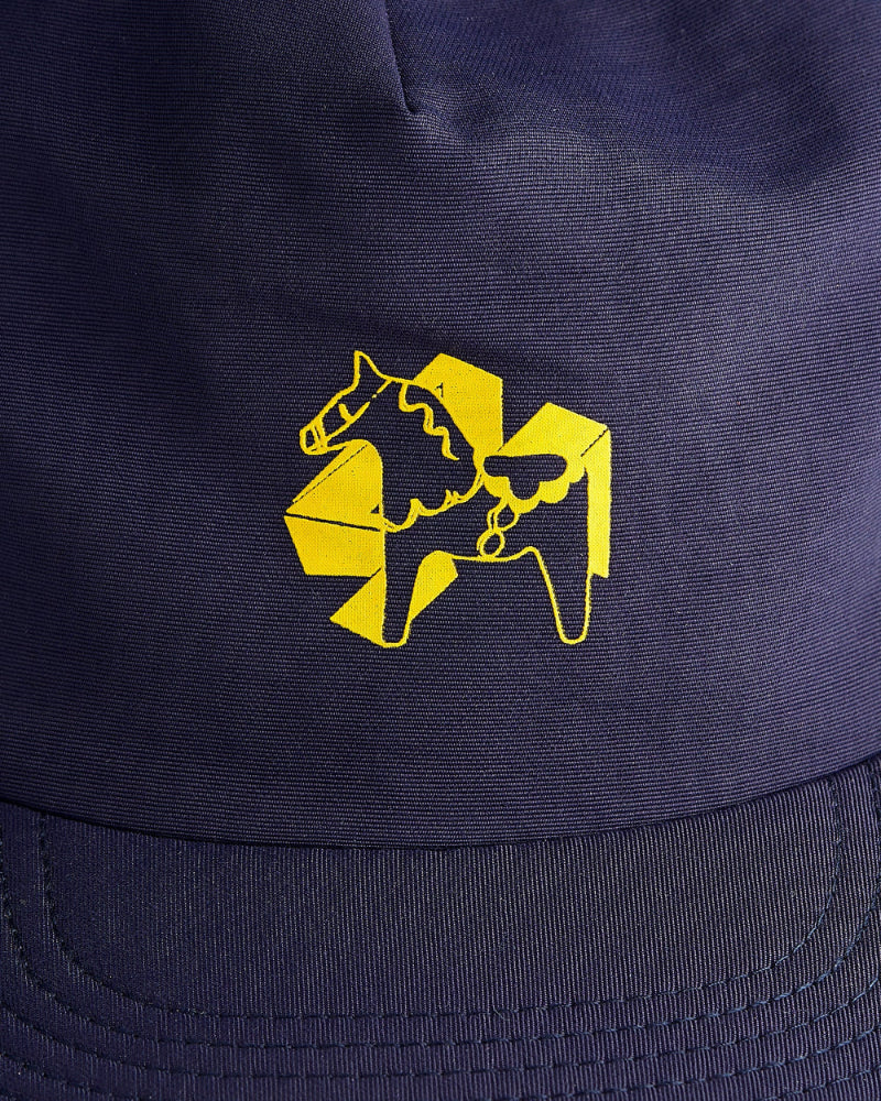 Close up on a the front of a navy blue dad cap with a yellow 4Msb logo with a yellow dala horse