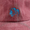 Vintage red 4Msb dad cap, close-up on the embroidered blue Dala horse on the front.