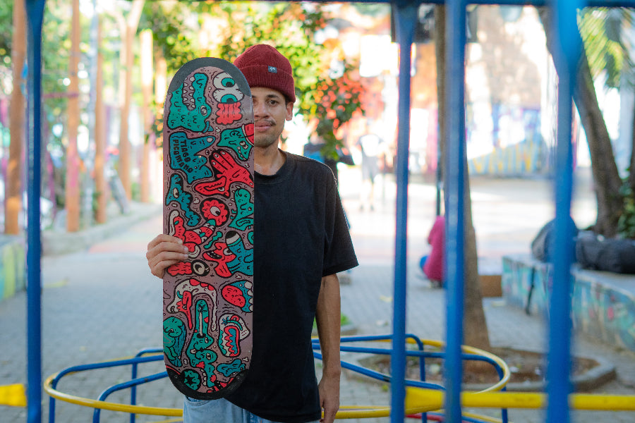 4Msb skateboard deck Doodle TIPtech multicolour, signature deck Pro rider Tiago Picomano. Team rider Bruno Vinicius holding the deck.