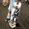 A skateboarder on a wooden outdoor ground holding assembled 4Msb skateboard deck Jättar (giants) with TIPtech, part of the folklore series.