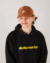 Skater wearing a black skateovation hoodie core and a 4Msb camel brown corduroy cap Quatro.