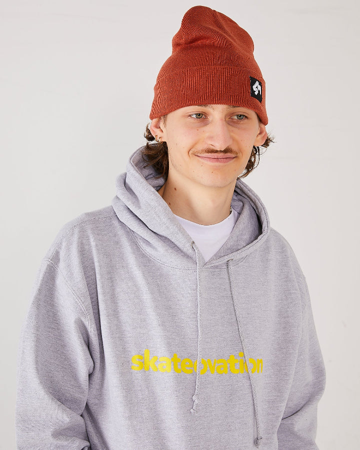 Skaterboarder wearing 4Msb cuffed beanie quatro rust and skateovation hoodie core heather grey.