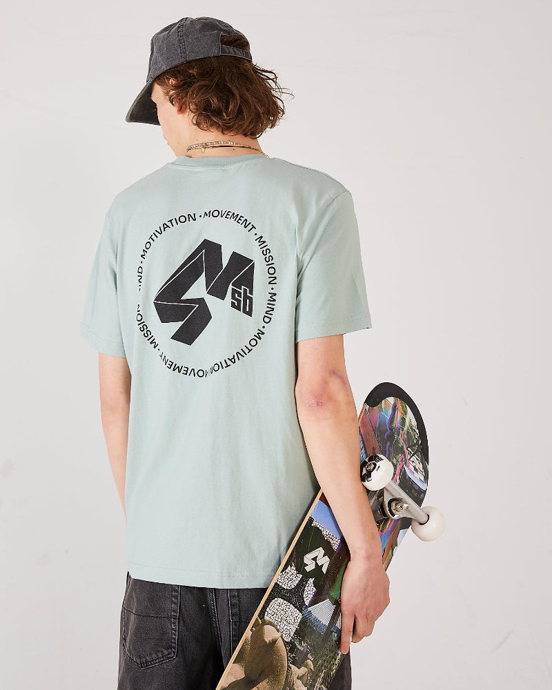 Skaer wearing a aloe green t-shirt 4Msb logo quatro on the back, dad cap dala horse, holding a 4Msb skateboard collage Engelbrekt.