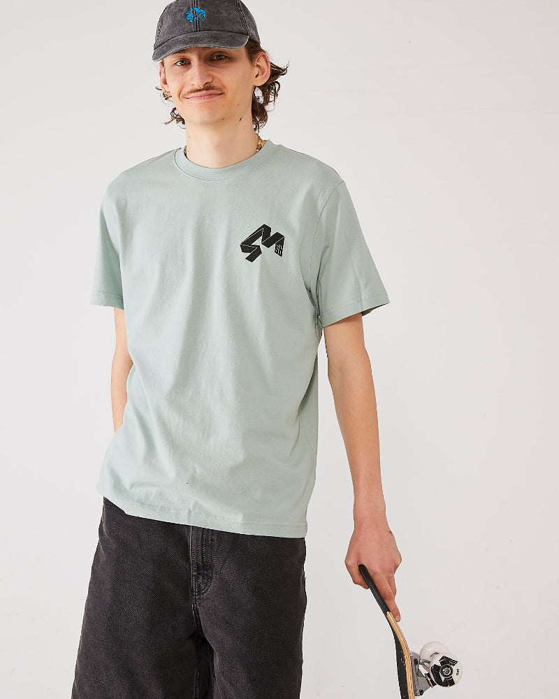 Skater wearing a aloe green 4Msb  t-shirt with the Quatro logo, a dad cap dala horse,  holding a 4Msb TIPtech skateboard.
