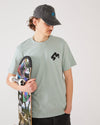 skater wearing a aloe green t-shirt with a 4Msb logo, a dad cap dala horse vintage black, holding a TIPtech skateboard Engelbrekt.