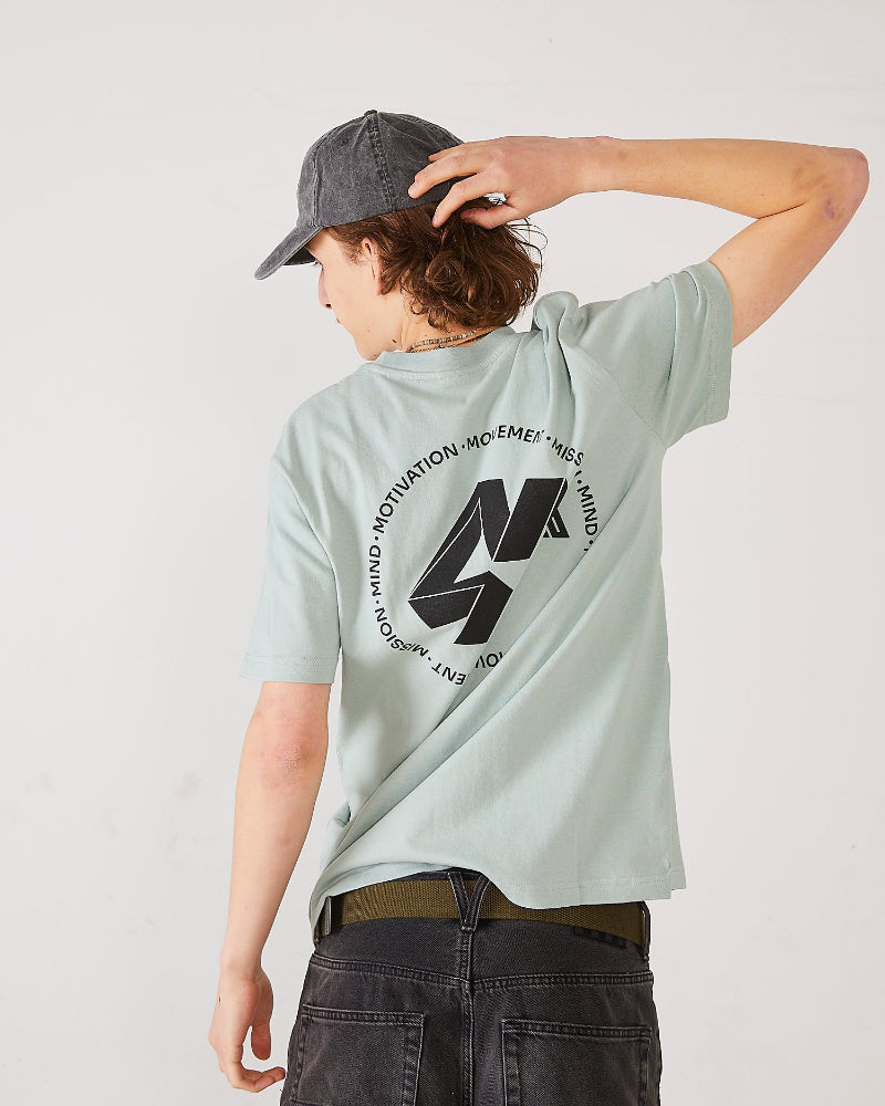 Skater wearing a light green t-shirt with a black 4Msb logo Quatro on the back, a 4Msb dad cap vintage black and SO webbing belt olive green.
