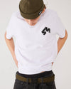 Skateboarder wearing 4Msb fisherman beanie Edge olive, 4Msb t-shirt Quatro white, SO webbing belt olive.