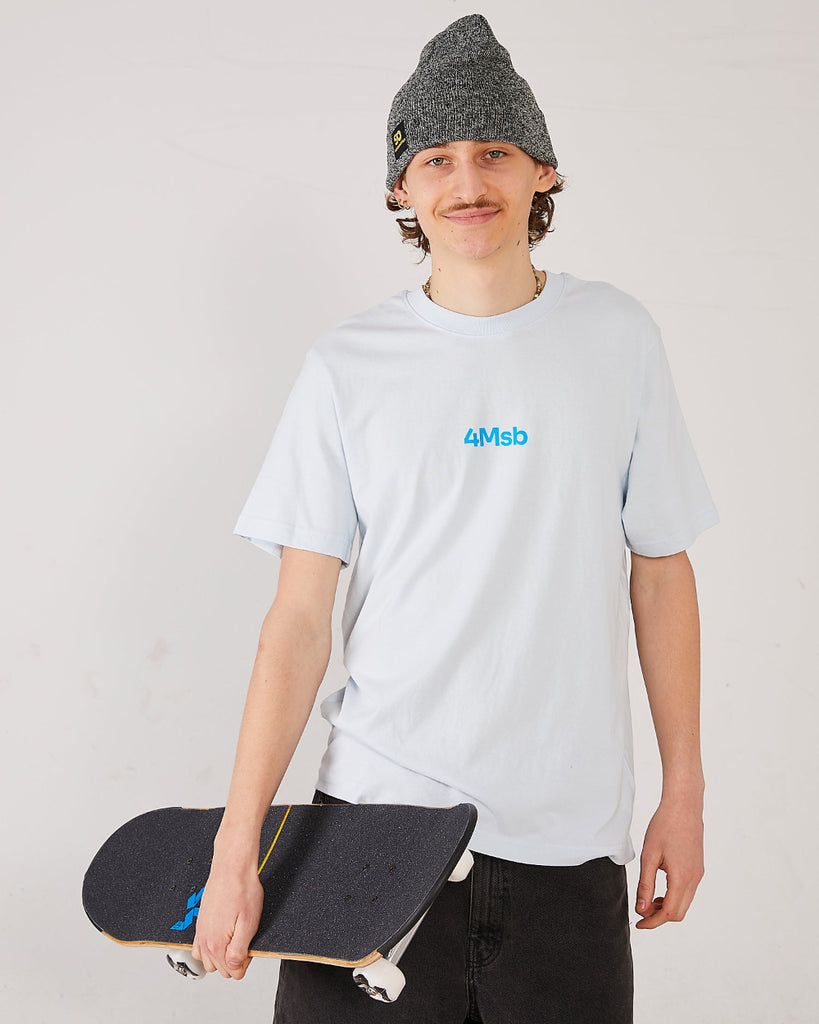 Skater wearing a light blue t-shirt with 4Msb logo, a antique grey cuffed beanie SO holding a skateboard.