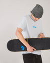 Skater wearing a ice blue 4Msb t-shirt, a antique grey SO cuffed beanie, holding a skateboard with a 4Msb griptape Quatro.