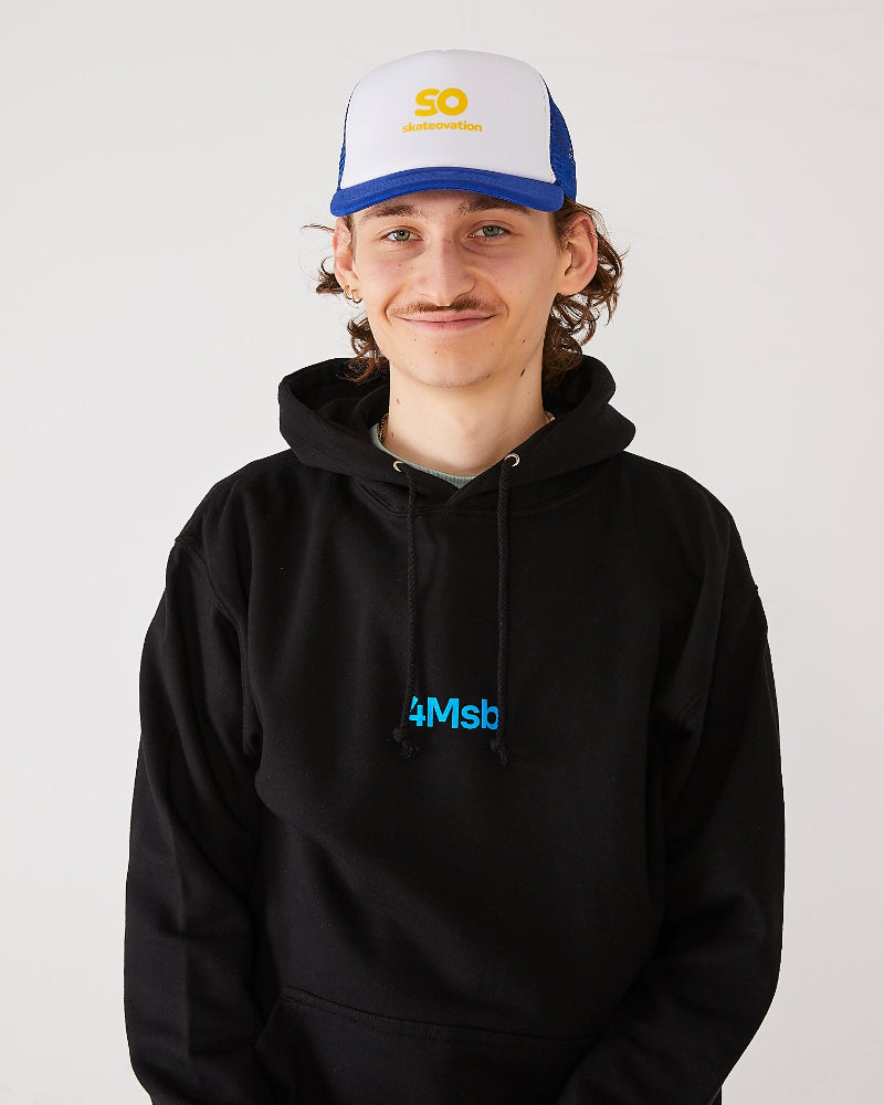 Skateboarder wearing a black 4Msb hoodie and a blue and white skateovation SO trucker cap.