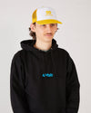 Skater wearing a black 4Msb hoodie and a white and yellow trucker cap SO.