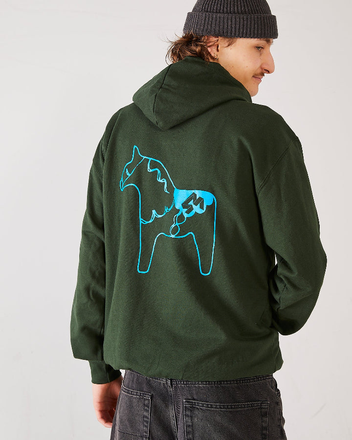 Skater wearing 4Msb fisherman beanie and 4Msb hoodie in the color forest green with a dala horse in blue on the back.