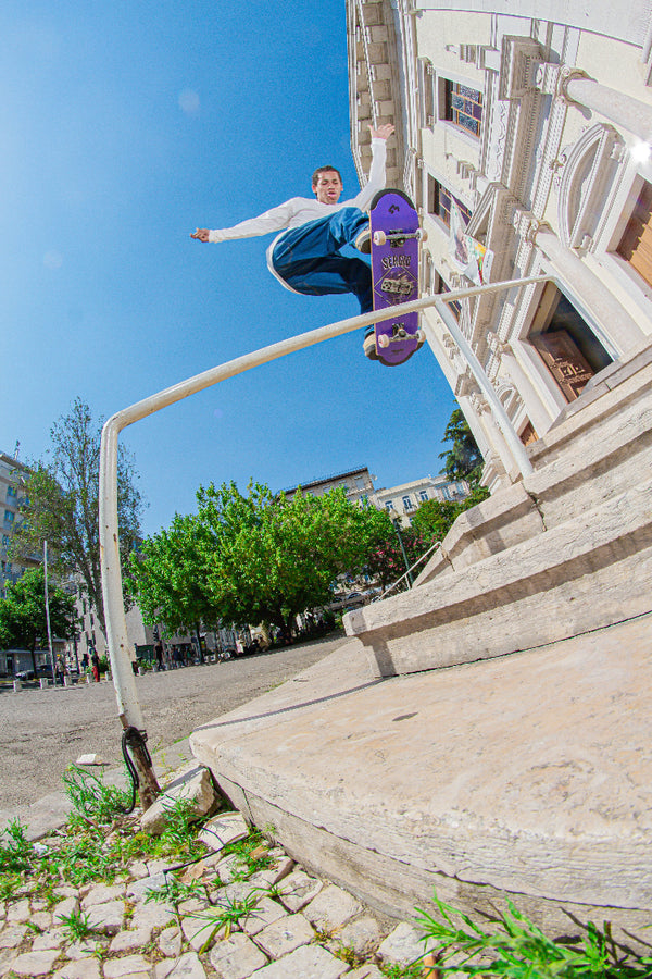 Team skater Bruno Vinicius railing in Lisbon, seen on a 4Msb Sérgio André skateboard deck in lila.