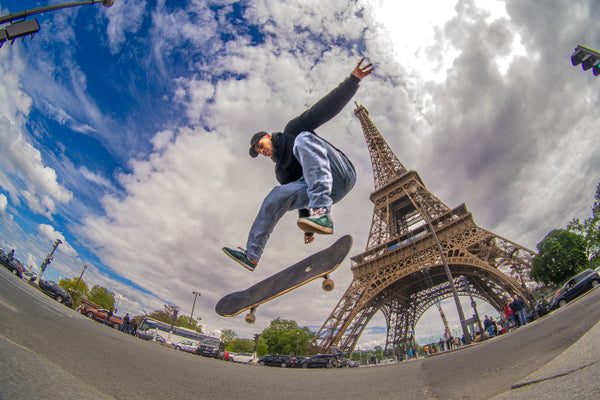 4Msb team rider Bruno Vinicius in the air doing a skateboard trick infront of the Eiffel tour in Paris.