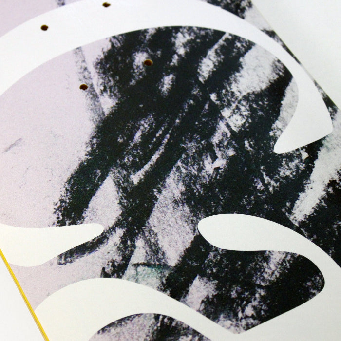 Close up of the Cafe Skateboard Deck JLH in Lavender/Green, a pastel lavender colored deck with abstract green and black scribbles on it as well as the word 'cafe' written in large.