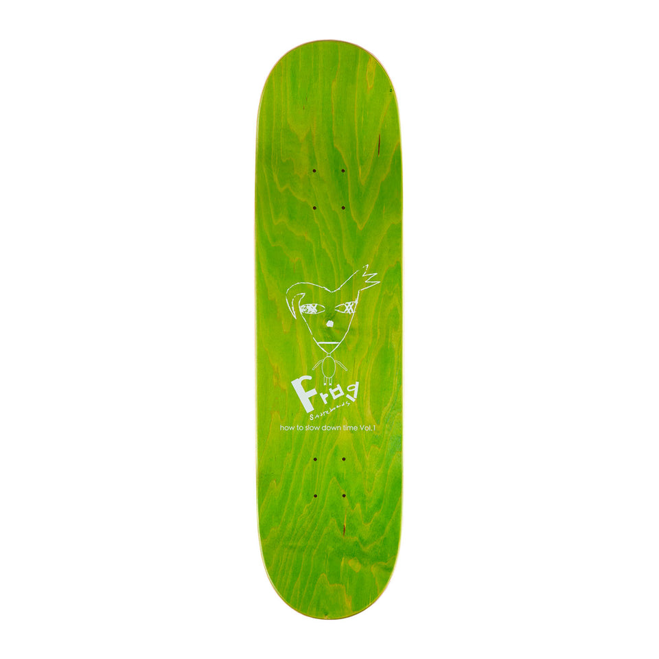 Top view of frog skateboards Pat G technique deck, its dyed light green and has a cartoon creature on it as well as Frog branding.