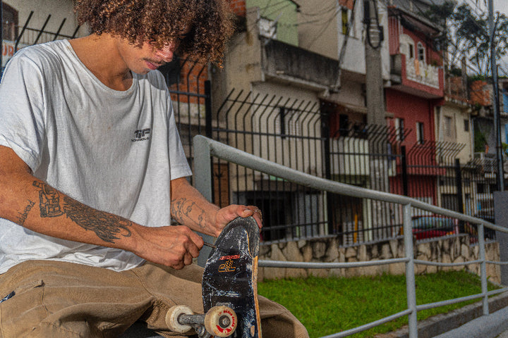 4Msb team rider Hadriel Junior adjusting screws on his TIPtech skateboard.