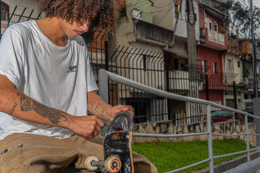 4Msb team rider Hadriel Junior adjusting screws on his TIPtech skateboard.