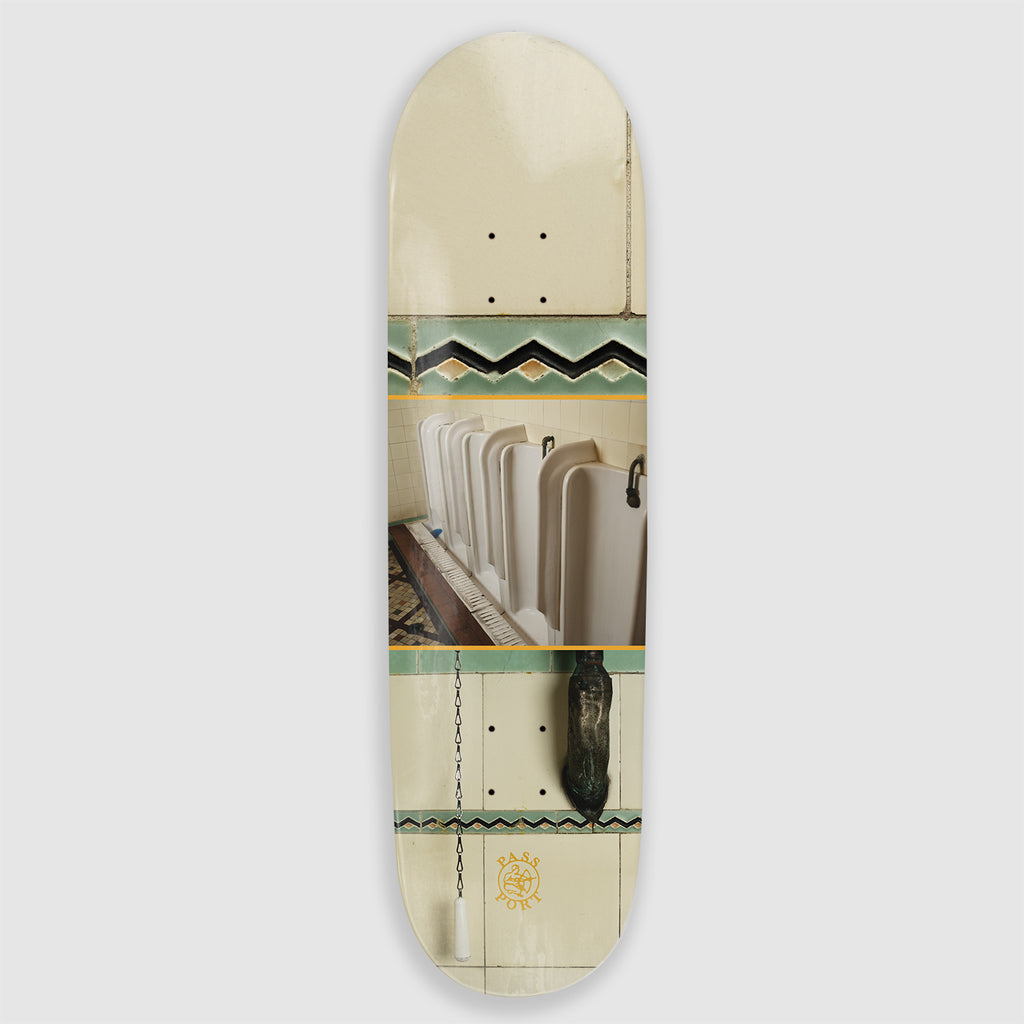 The Pass~Port Skateboard Deck  Grout from the Dunny Hunt Series depicts a worn down bathroom with cream and green coloring.