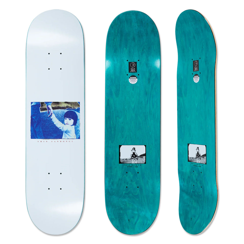 Polar Skateboard deck with the bottom side printed with a blue design in the middle, a child holding a hand, on a white background. And the top side a dyed turquoise wood color.