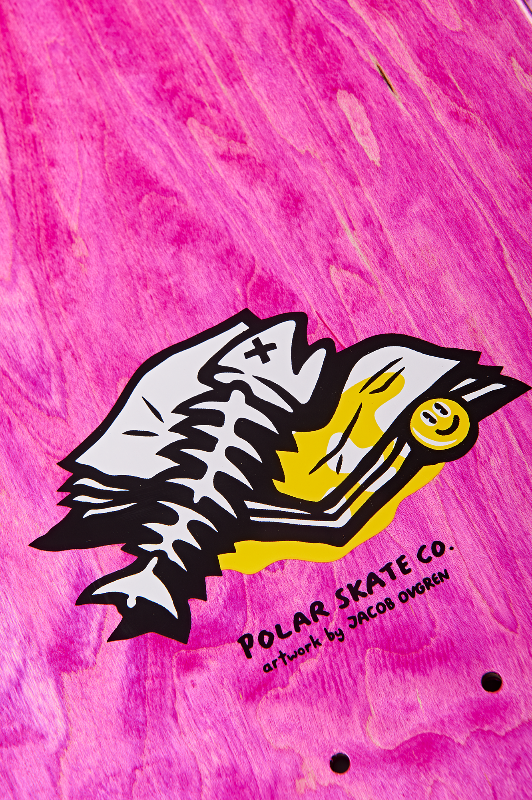 Skateboard deck with a fish design and 'Polar Skate Co.' branding on a pink background.