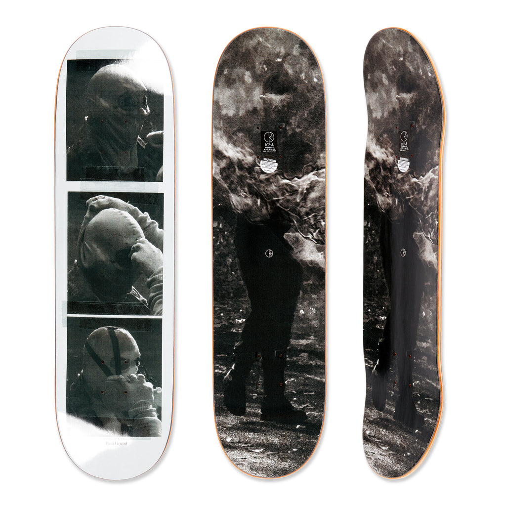 Three views of the Polar skateboard deck for pro rider Paul Grund, Stuntman A. The bottom graphic shows black and white images of a stuntman getting ready, the top graphic shows a stuntman on fire.