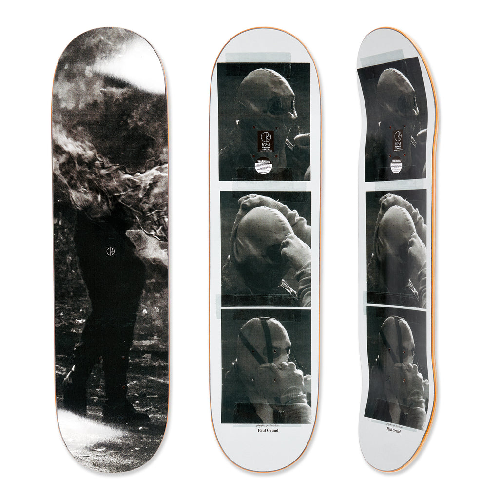 Three views of the Polar skateboard deck for pro rider Paul Grund, Stuntman B. The bottom graphic shows a stuntman on fire, the top graphic shows black and white images of a stuntman getting ready.