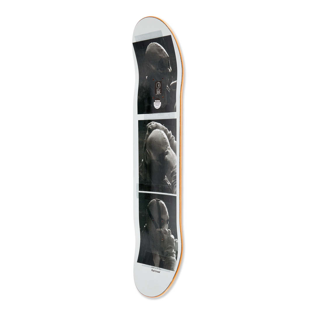 Side view of the Polar skateboard deck for pro rider Paul Grund, Stuntman B. The bottom graphic shows a stuntman on fire, the top graphic shows black and white images of a stuntman getting ready.