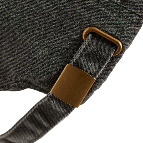 Close-up of a SO dad cap vintage black back  showing strap and brass buckle.