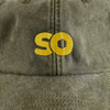 skateovation dad cap SO in the colour vintage olive (green), close-up of the embroidered SO logo in yellow on the front.