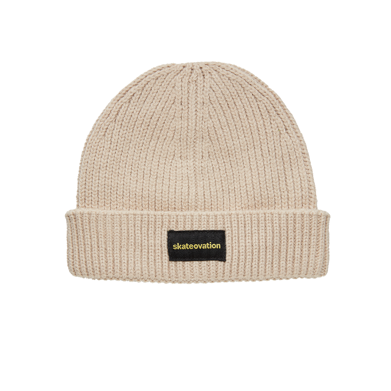 The Skateovation harbour beanie core in the color oatmeal. skateovation embroidered in yellow on black on the front.