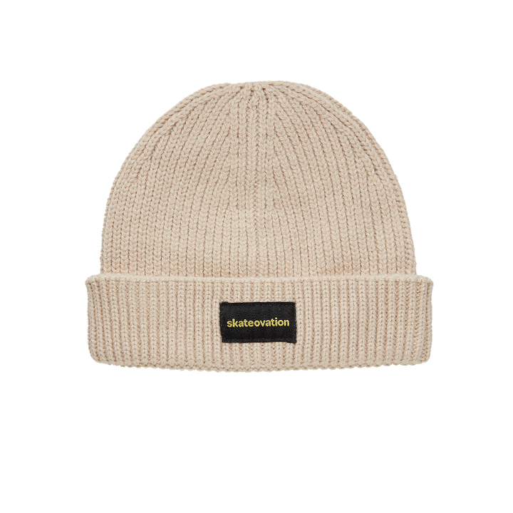 The Skateovation harbour beanie core in the color oatmeal. skateovation embroidered in yellow on black on the front.