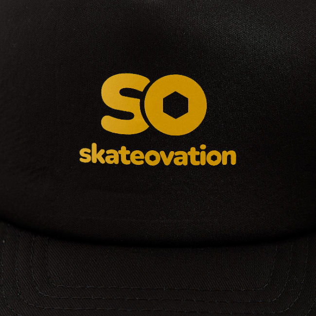 Black trucker cap, close-up in the yellow 'SO skateovation' logo on the front.