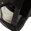 Close-up of a black mesh trucker cap with a strap.