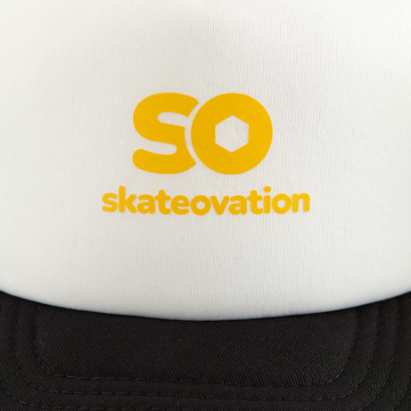 White and black trucker cap SO, close-up yellow 'skateovation' logo on the front.
