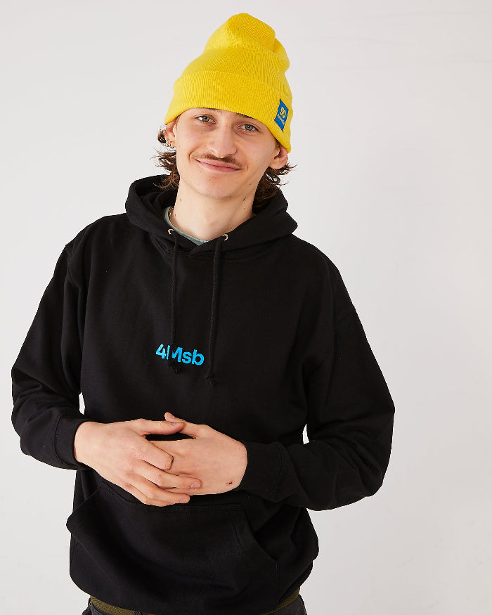 skater wearing a yellow SO skateovation cuffed beanie and black 4Msb hoodie.